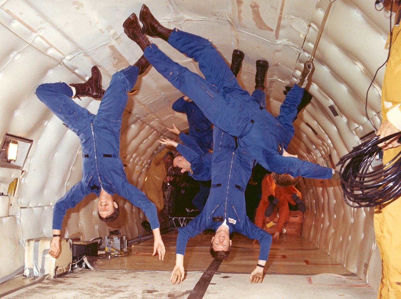 People floating inside the cabin of an aircraft during a parabolic zero-gravity flight